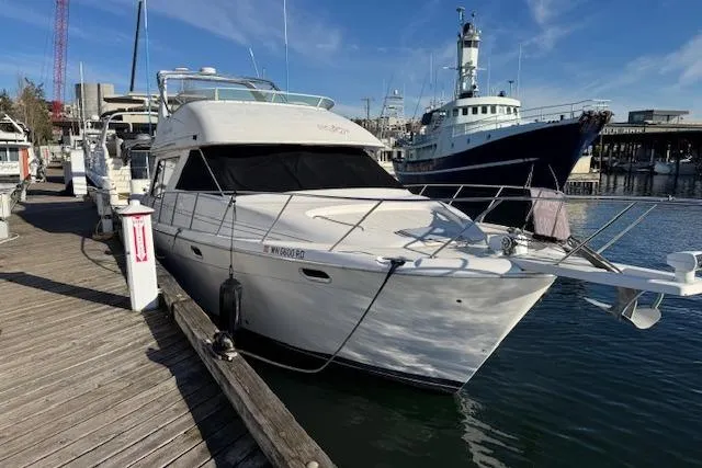 The Image of 1995 Bayliner 3988 Motoryacht docked at marina, sunny day, clear sky. - 0
