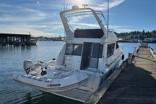Slide: The Image of 1995 Bayliner 3988 Motoryacht docked at marina under clear blue sky. - 1