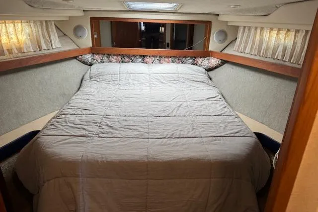 Slide: The Image of Cozy bedroom interior of 1995 Bayliner 3988 Motoryacht with large bed and curtains. - 14