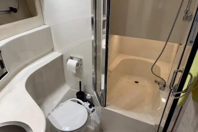 Slide: The Image of 1995 Bayliner 3988 Motoryacht bathroom with shower, toilet, and sink. - 18