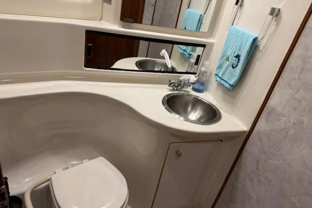 Slide: The Image of 1995 Bayliner 3988 Motoryacht bathroom with sink, mirror, and toilet. - 21