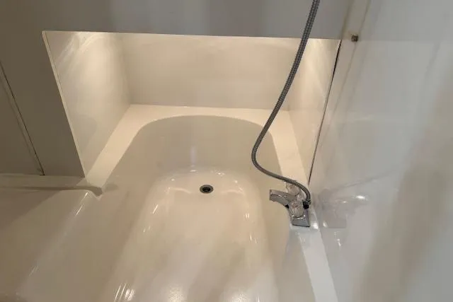 Slide: The Image of 1995 Bayliner 3988 Motoryacht bathroom with white bathtub and chrome faucet. - 23