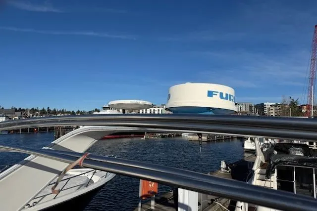 Slide: The Image of 1995 Bayliner 3988 Motoryacht docked, featuring radar equipment, under clear blue sky. - 24