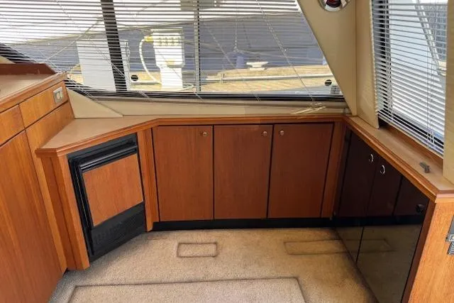 Slide: The Image of Interior of 1995 Bayliner 3988 Motoryacht with wood cabinetry and carpeted flooring. - 4