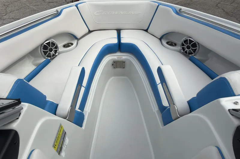 Slide: The Image of 2026 Crownline 220 SS boat interior with blue and white seating and built-in speakers. - 13