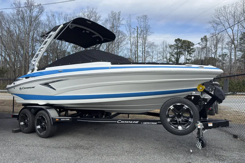 Slide: The Image of 2026 Crownline 220 SS boat on trailer, featuring sleek design and blue accents. - 3