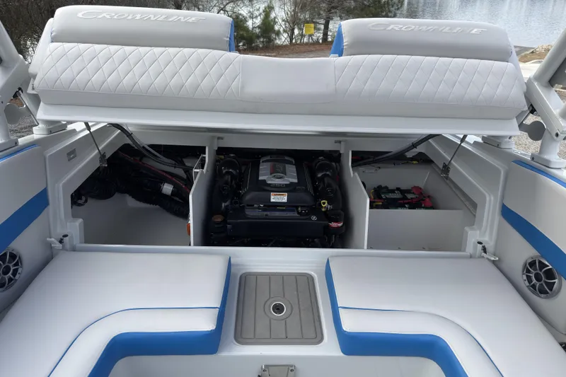 Slide: The Image of 2026 Crownline 220 SS boat engine compartment with open seating and storage. - 6