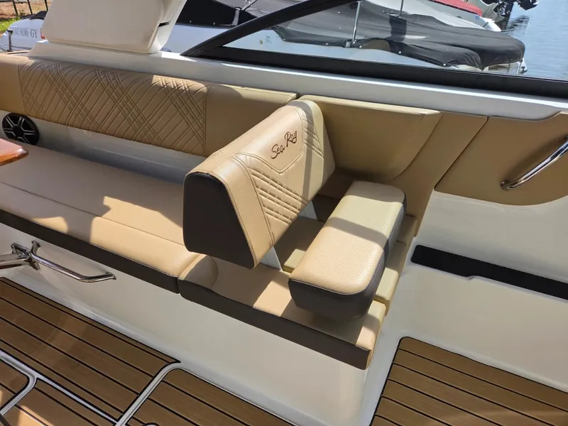 Slide: The Image of Interior of a Sea Ray SDX 270 Outboard with beige upholstery and wooden flooring. - 11