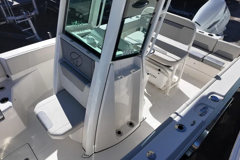 Slide: The Image of 2026 Sailfish 252 CC boat interior with seating and console, showcasing modern design. - 10