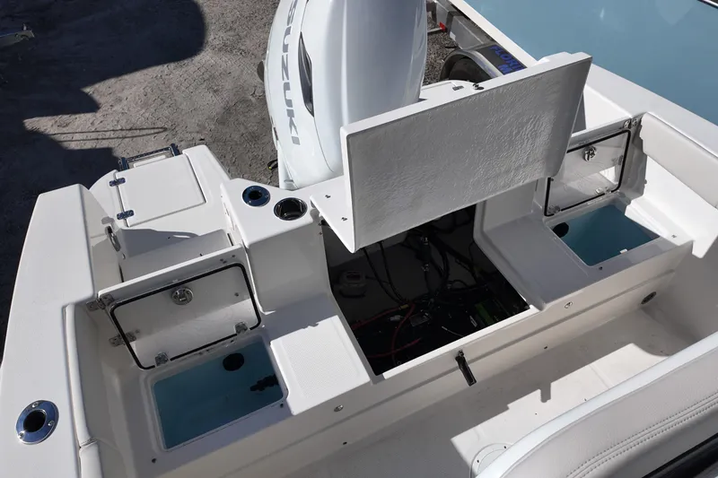 Slide: The Image of 2026 Sailfish 252 CC boat interior with open storage compartments and Suzuki engine. - 14