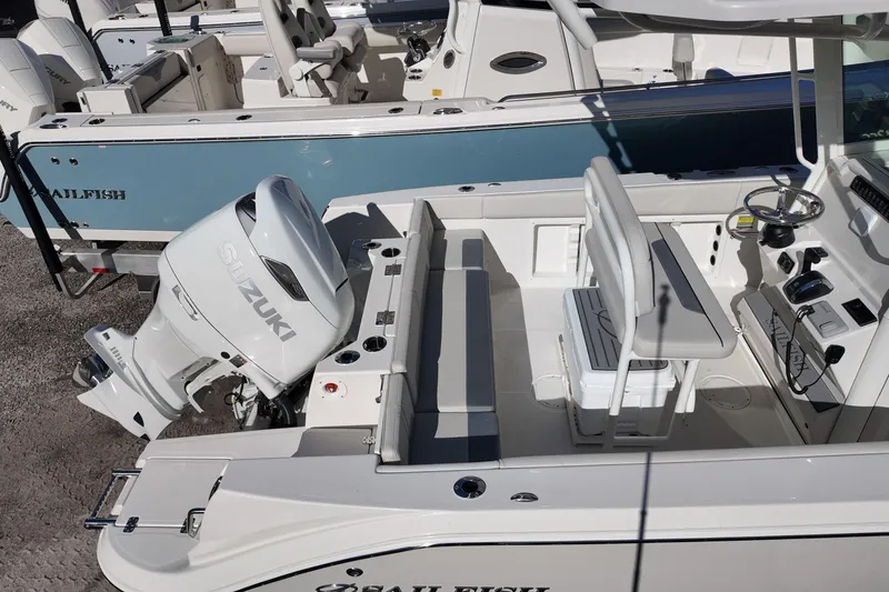 Slide: The Image of 2026 Sailfish 252 CC boat with Suzuki outboard motor, featuring spacious seating and modern controls. - 16