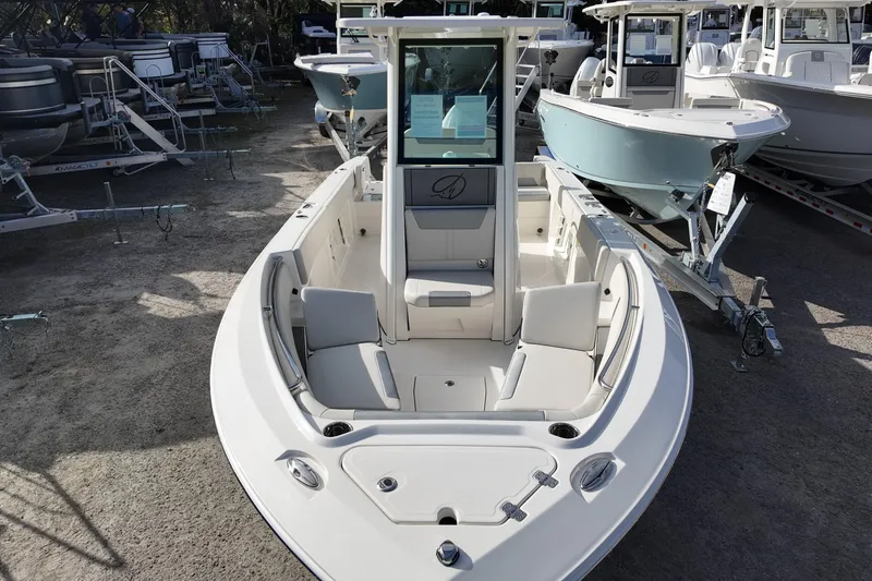 Slide: The Image of 2026 Sailfish 252 CC boat with spacious seating, displayed outdoors among other boats. - 9