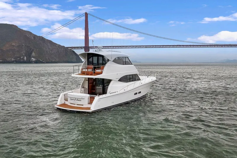 Slide: The Image of 2014 Maritimo M50 yacht cruising near a large suspension bridge. - 10