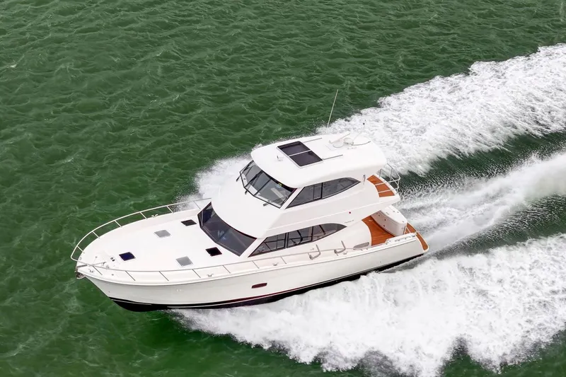 Slide: The Image of 2014 Maritimo M50 yacht cruising on green ocean waters. - 12