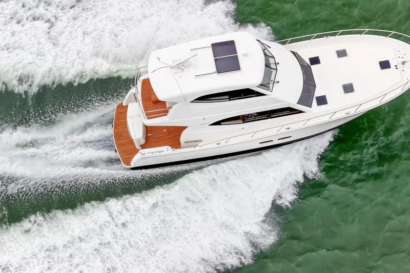 Slide: The Image of 2014 Maritimo M50 yacht cruising on green water, aerial view. - 13