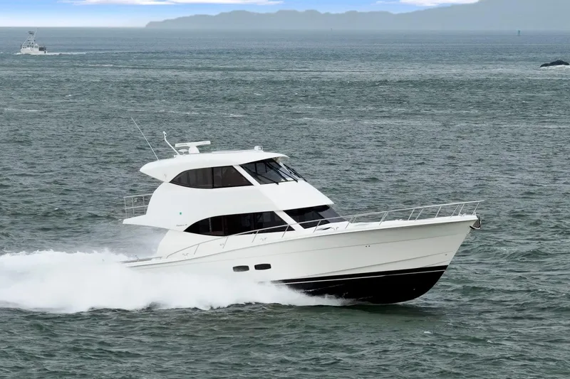 Slide: The Image of 2014 Maritimo M50 yacht cruising on open water, showcasing sleek design and performance. - 14