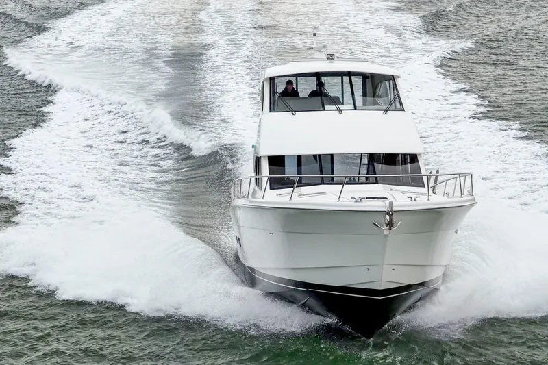 Slide: The Image of 2014 Maritimo M50 yacht cruising on open water, creating a dynamic wake. - 2