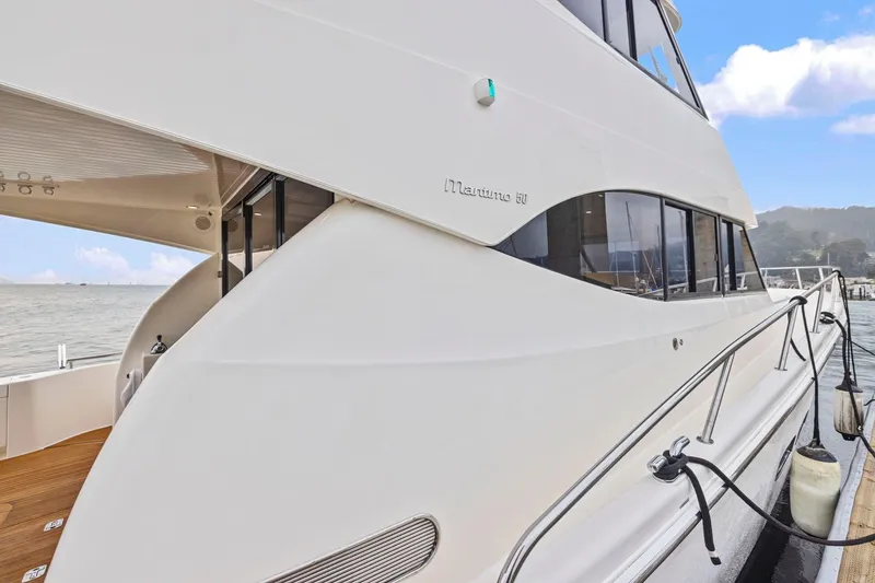 Slide: The Image of 2014 Maritimo M50 yacht docked, showcasing sleek design and modern features. - 21