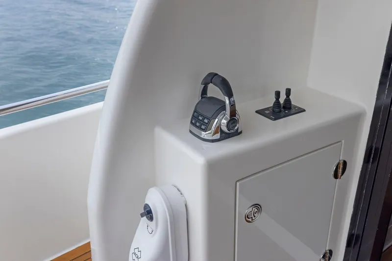 Slide: The Image of 2014 Maritimo M50 yacht control panel with throttle and joystick. - 25