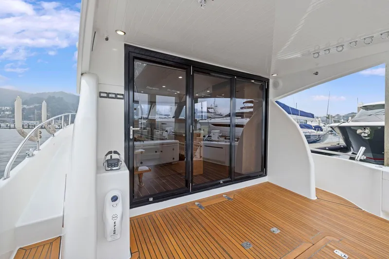 Slide: The Image of 2014 Maritimo M50 yacht deck with sliding glass doors and marina view. - 28