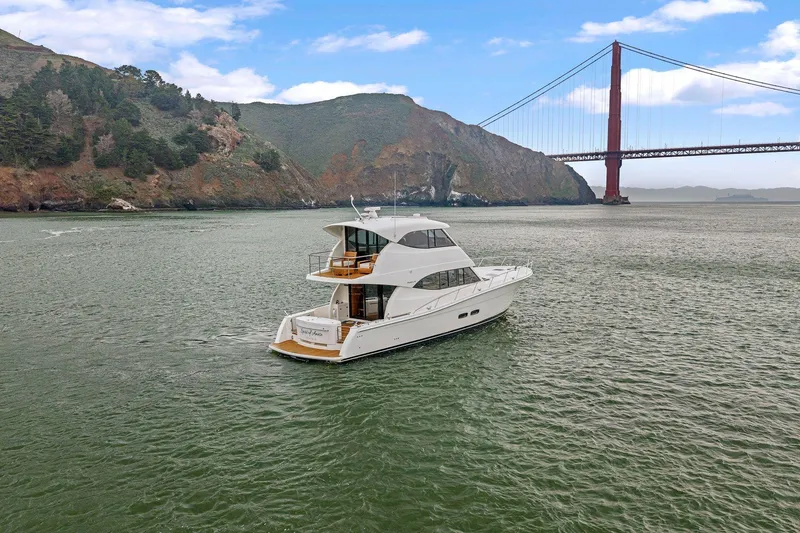 Slide: The Image of 2014 Maritimo M50 yacht cruising near iconic red suspension bridge. - 3