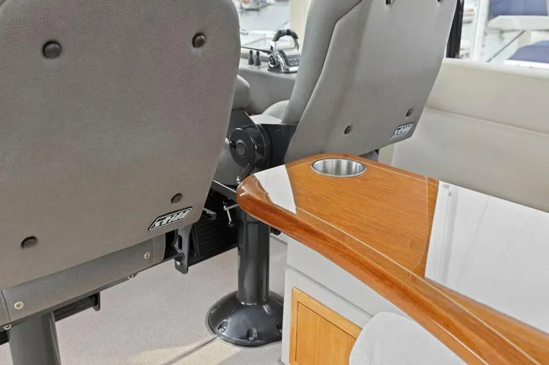 Slide: The Image of Interior of 2014 Maritimo M50 yacht with plush seating and wooden table. - 49