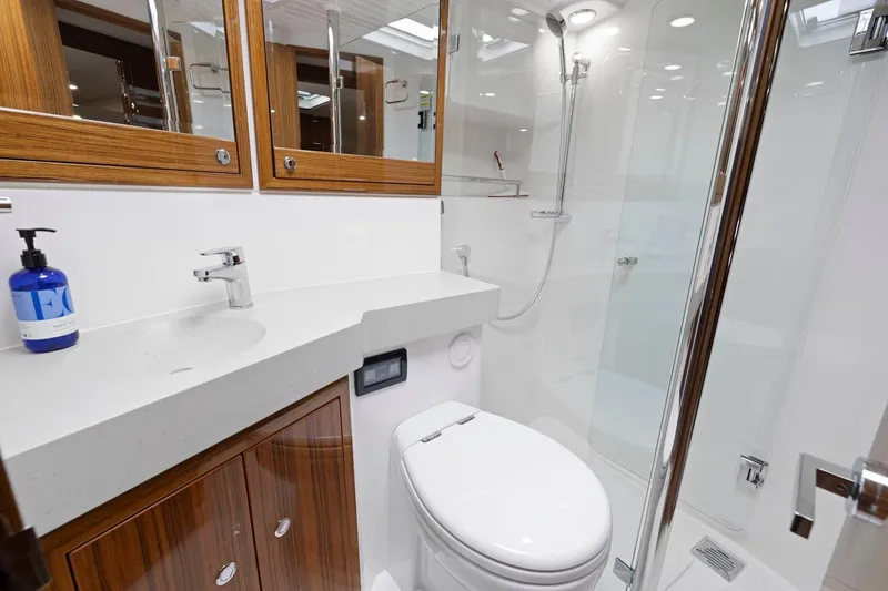 Slide: The Image of Luxurious bathroom in 2014 Maritimo M50 yacht with modern fixtures and wooden accents. - 69