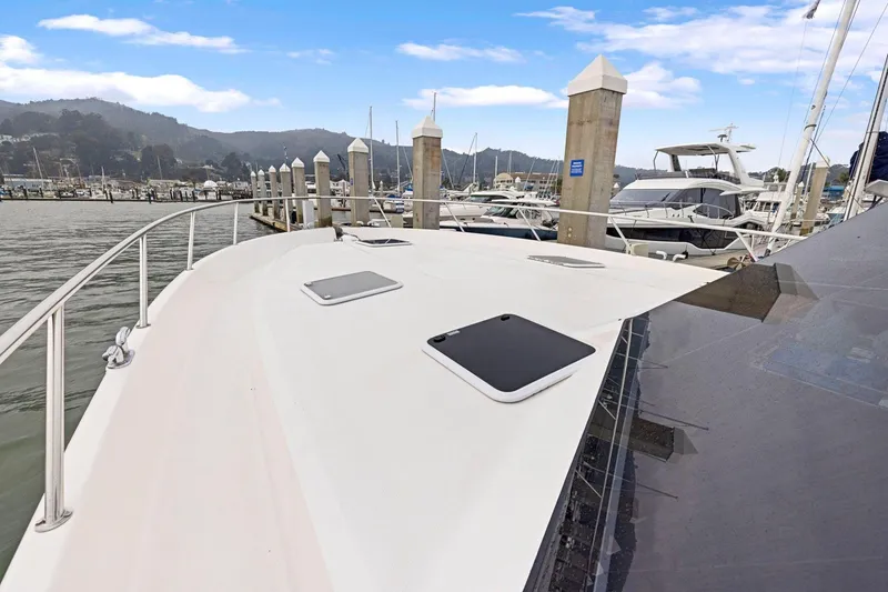 Slide: The Image of 2014 Maritimo M50 yacht docked at a marina with scenic mountain backdrop. - 78