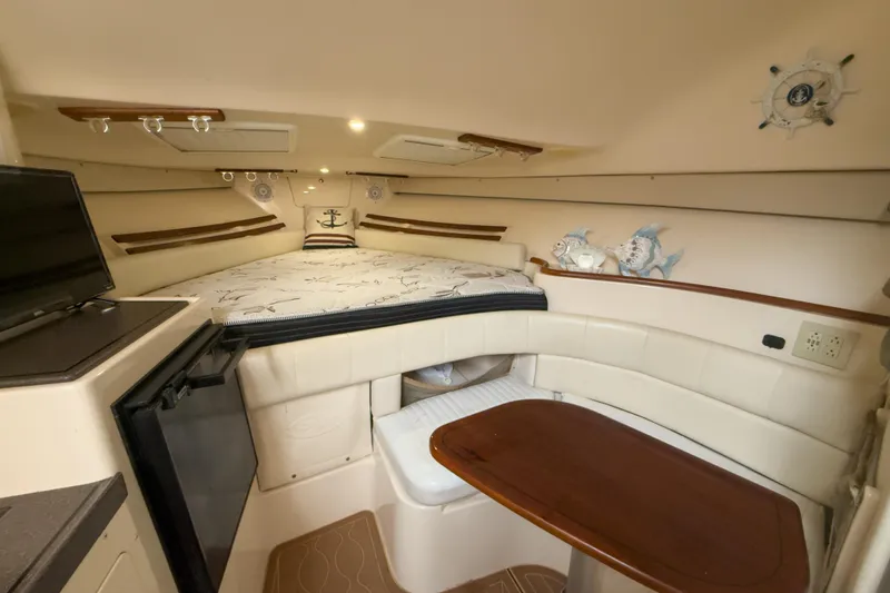 Slide: The Image of Interior of 2006 Grady-White Express 330 boat with cozy seating and bed area. - 13