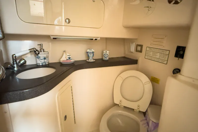 Slide: The Image of 2006 Grady-White Express 330 boat bathroom with sink, toilet, and nautical decor. - 17