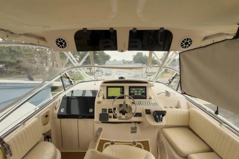Slide: The Image of Interior view of 2006 Grady-White Express 330 boat cockpit with modern controls and seating. - 2
