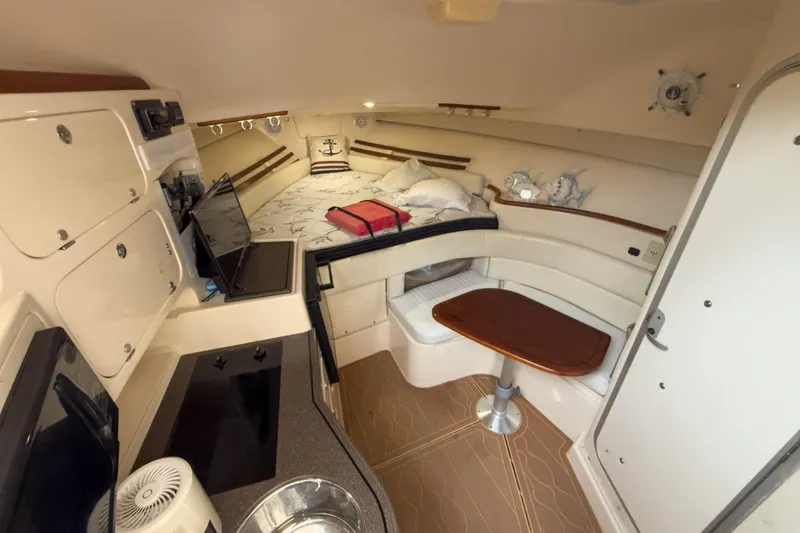 Slide: The Image of 2006 Grady-White Express 330 cabin interior with kitchenette, seating, and bed. - 27