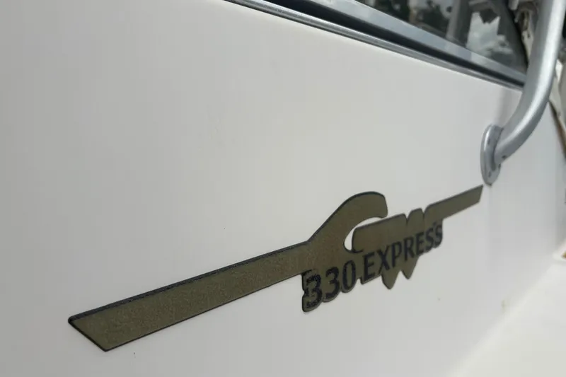 Slide: The Image of 2006 Grady-White Express 330 boat logo on white hull. - 3