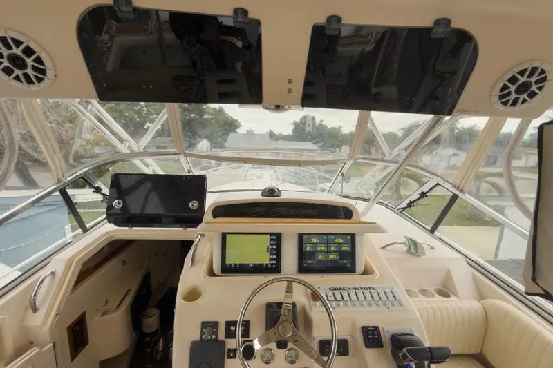 Slide: The Image of 2006 Grady-White Express 330 boat cockpit with navigation equipment and steering wheel. - 30