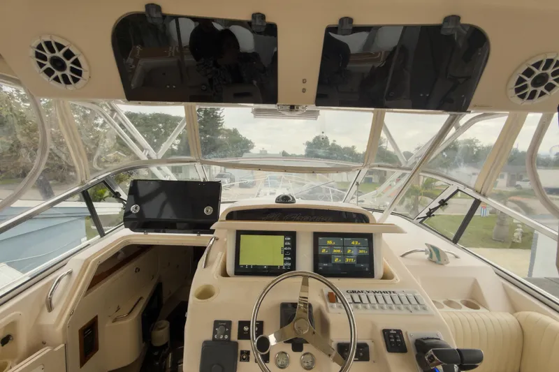 Slide: The Image of 2006 Grady-White Express 330 boat cockpit with navigation equipment and steering wheel. - 32