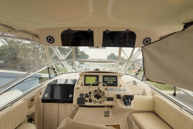 Slide: The Image of 2006 Grady-White Express 330 boat cockpit with modern navigation equipment and comfortable seating. - 33