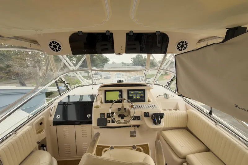 Slide: The Image of 2006 Grady-White Express 330 boat interior with steering wheel and navigation controls. - 34