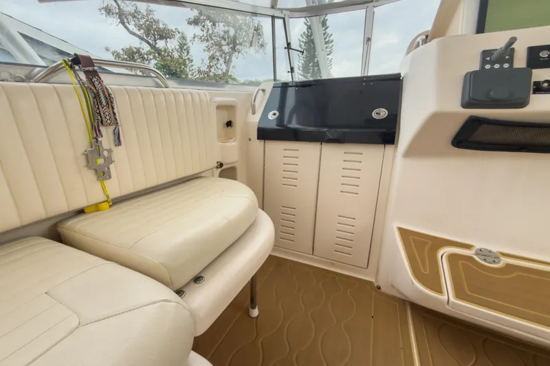 Slide: The Image of Interior of 2006 Grady-White Express 330 boat with beige seating and dashboard. - 35