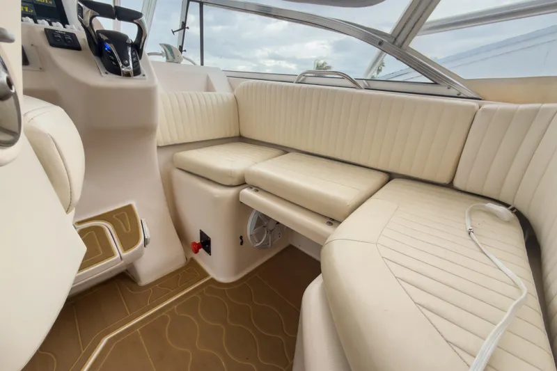 Slide: The Image of 2006 Grady-White Express 330 interior with beige seating and helm controls. - 36