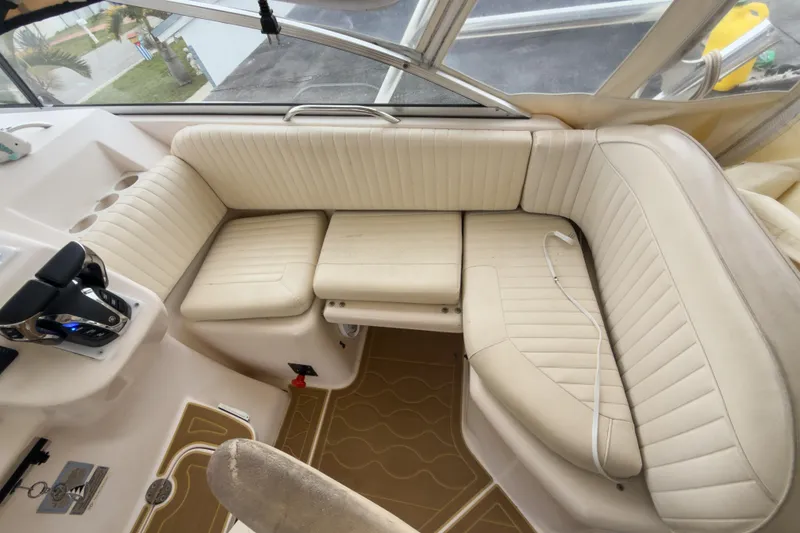 Slide: The Image of 2006 Grady-White Express 330 boat interior with beige seating and control panel. - 37