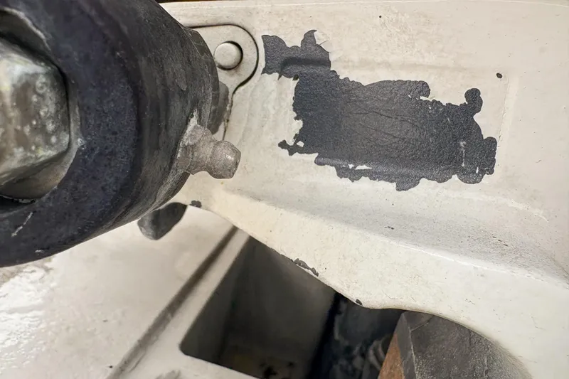 Slide: The Image of Close-up of a 2006 Grady-White Express 330 boat component with chipped paint. - 42