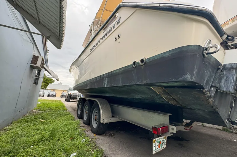 Slide: The Image of 2006 Grady-White Express 330 boat on trailer, parked beside a building. - 45
