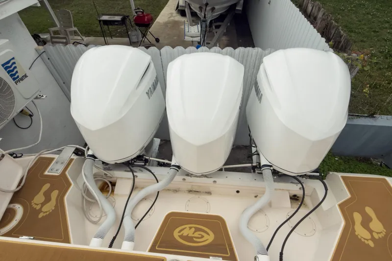Slide: The Image of 2006 Grady-White Express 330 with triple Yamaha outboard engines, docked in a yard. - 9