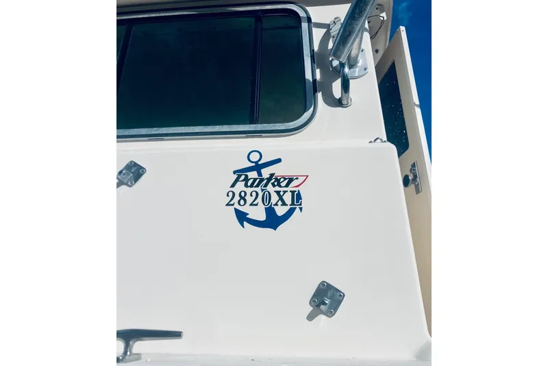 The Image of 2005 Parker 2820 XLD Sport Cabin boat with anchor logo and window detail. - 1