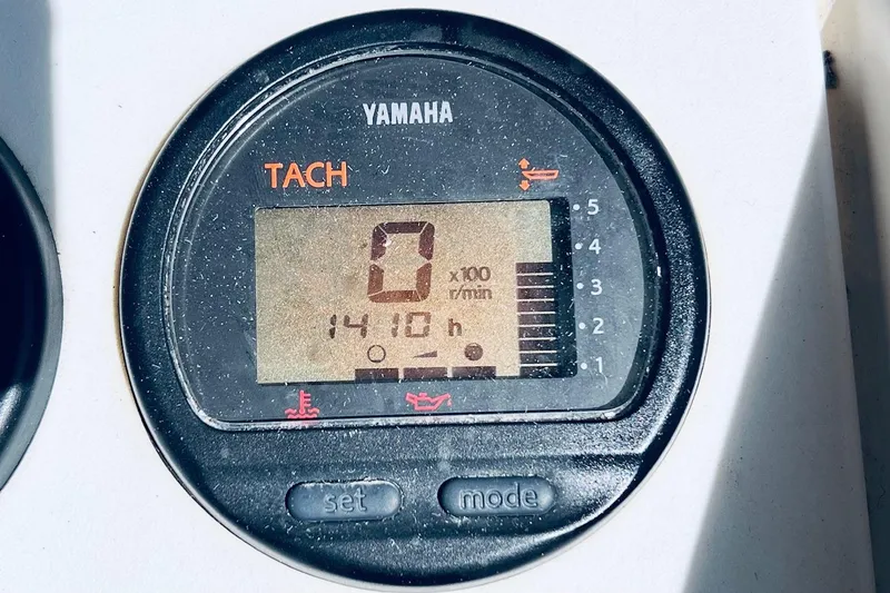 Slide: The Image of Yamaha tachometer displaying 1410 hours on a 2005 Parker 2820 XLD Sport Cabin boat. - 18