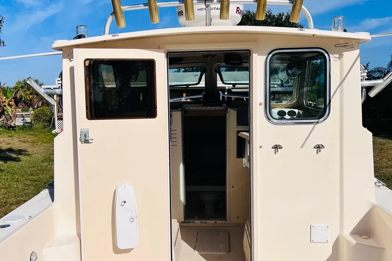 Slide: The Image of 2005 Parker 2820 XLD Sport Cabin boat with open cabin doors, exterior view. - 3