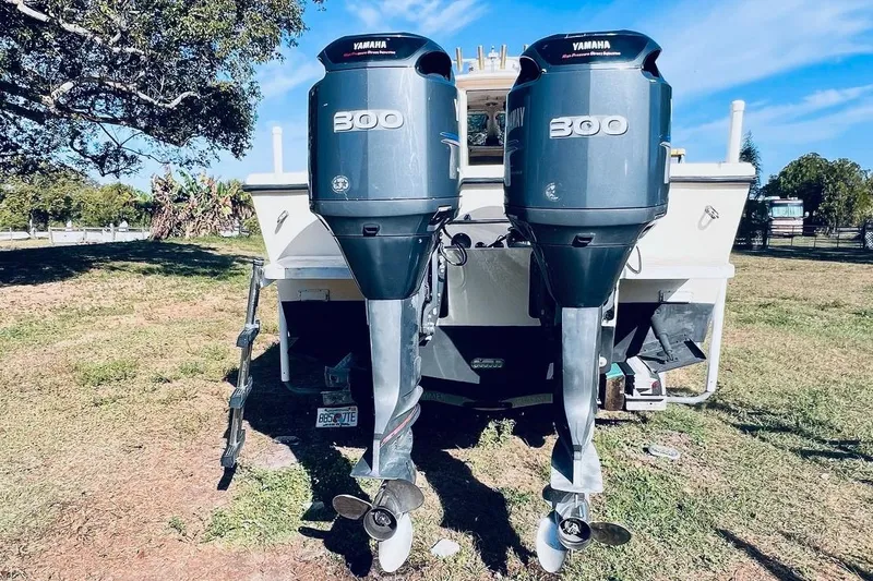 Slide: The Image of 2005 Parker 2820 XLD Sport Cabin with dual Yamaha 300 engines, parked on grass. - 5