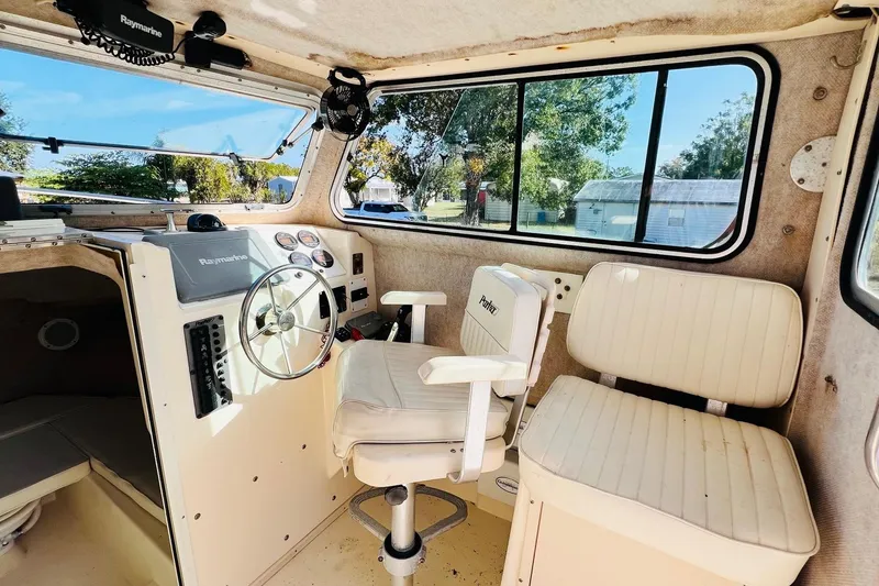 Slide: The Image of Interior of 2005 Parker 2820 XLD Sport Cabin with steering wheel and seating. - 10