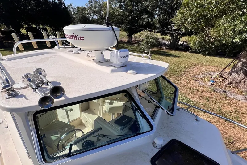 Slide: The Image of 2005 Parker 2820 XLD Sport Cabin boat with radar and horn on deck. - 4