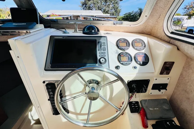 Slide: The Image of 2005 Parker 2820 XLD Sport Cabin helm with steering wheel and navigation instruments. - 9